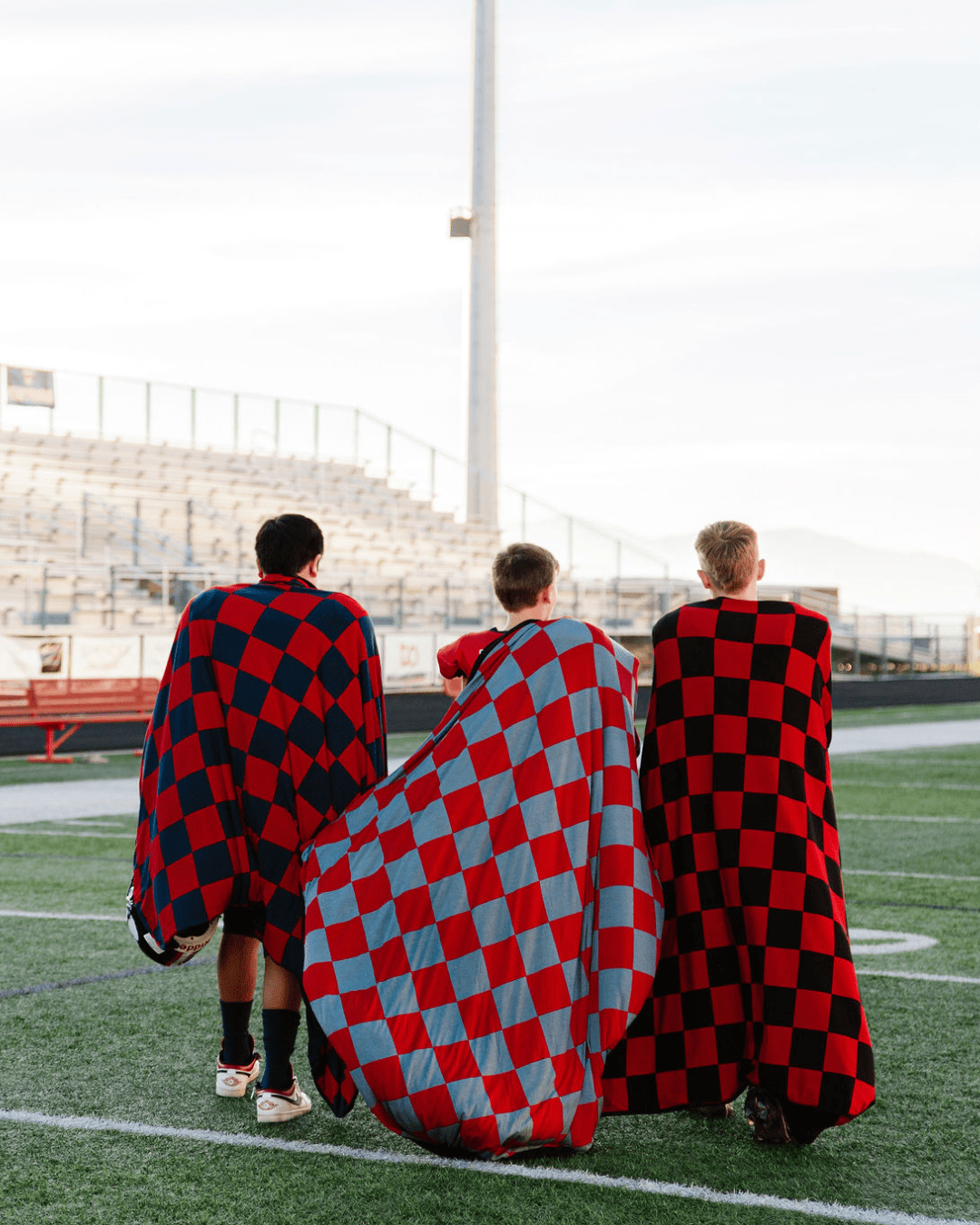 Cheer on your favorite team while saying cozy wrapped in a Pipermoon gameday hug blanket.