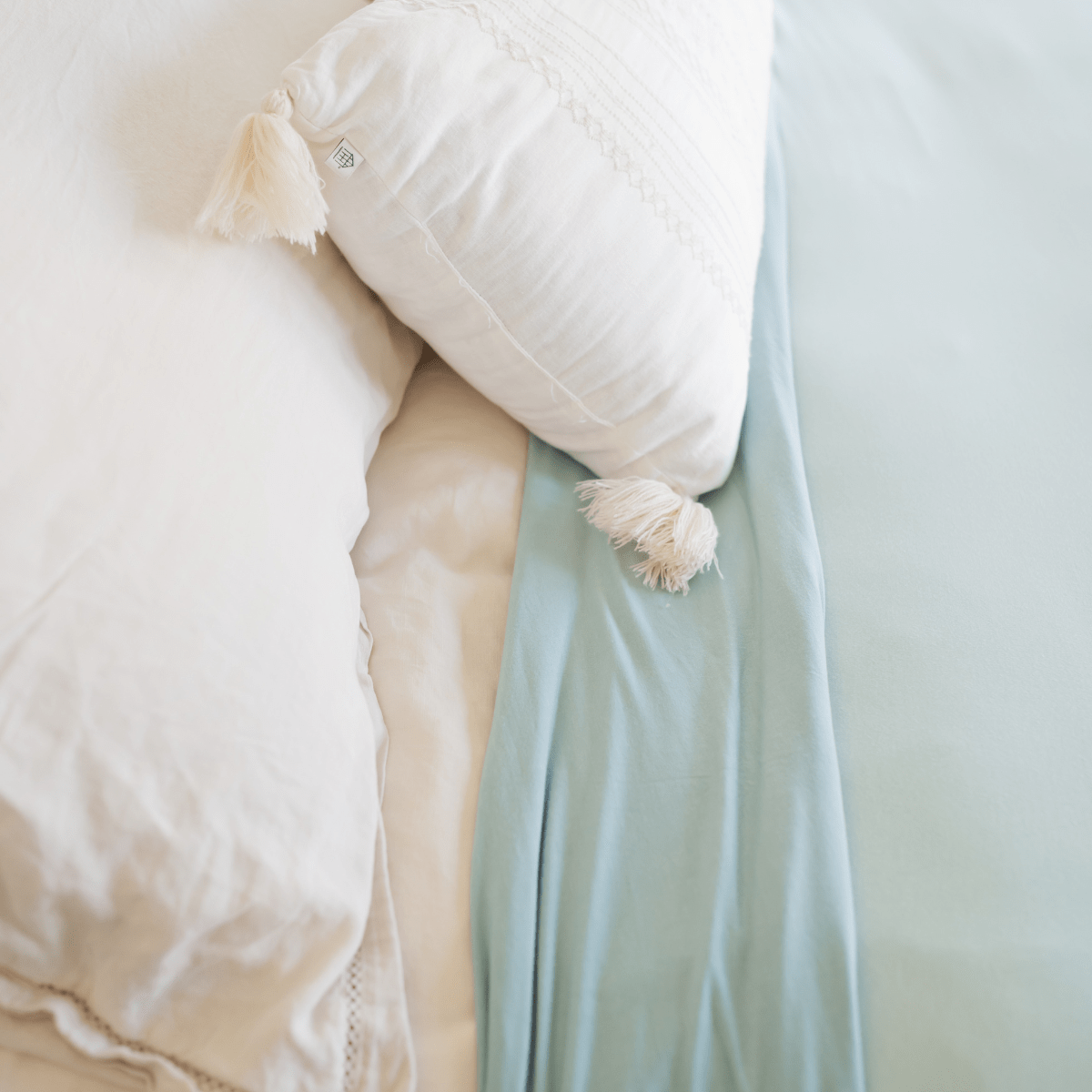 Two toned and two layered bed blankets in sea glass powder blue.