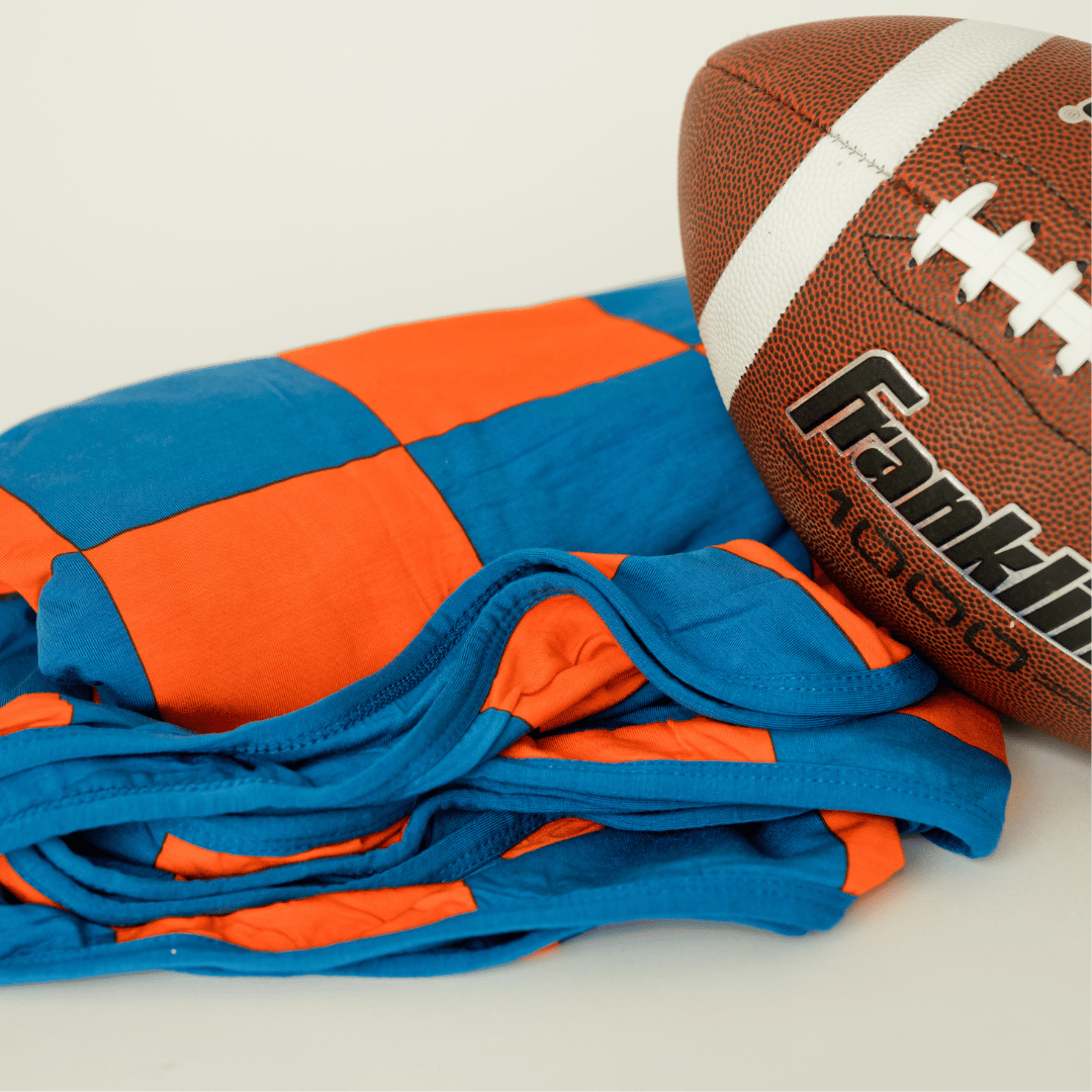 Orange and blue checkered adult swaddle blanket perfect for sports fans.