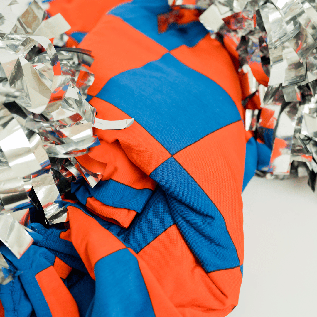 Modern cozy oversized blanket in blue and orange checks for staying cozy while showing your team pride.