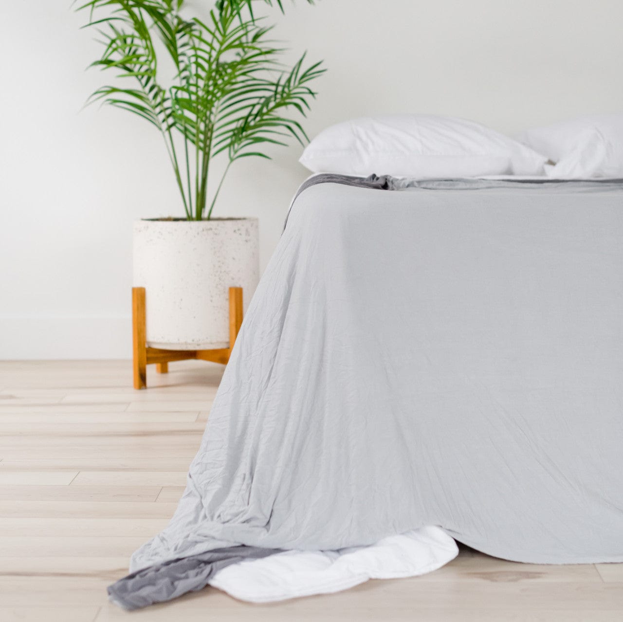 Queen size, temperature regulating, bed blanket in light grey on one side and charcoal gray on the other.