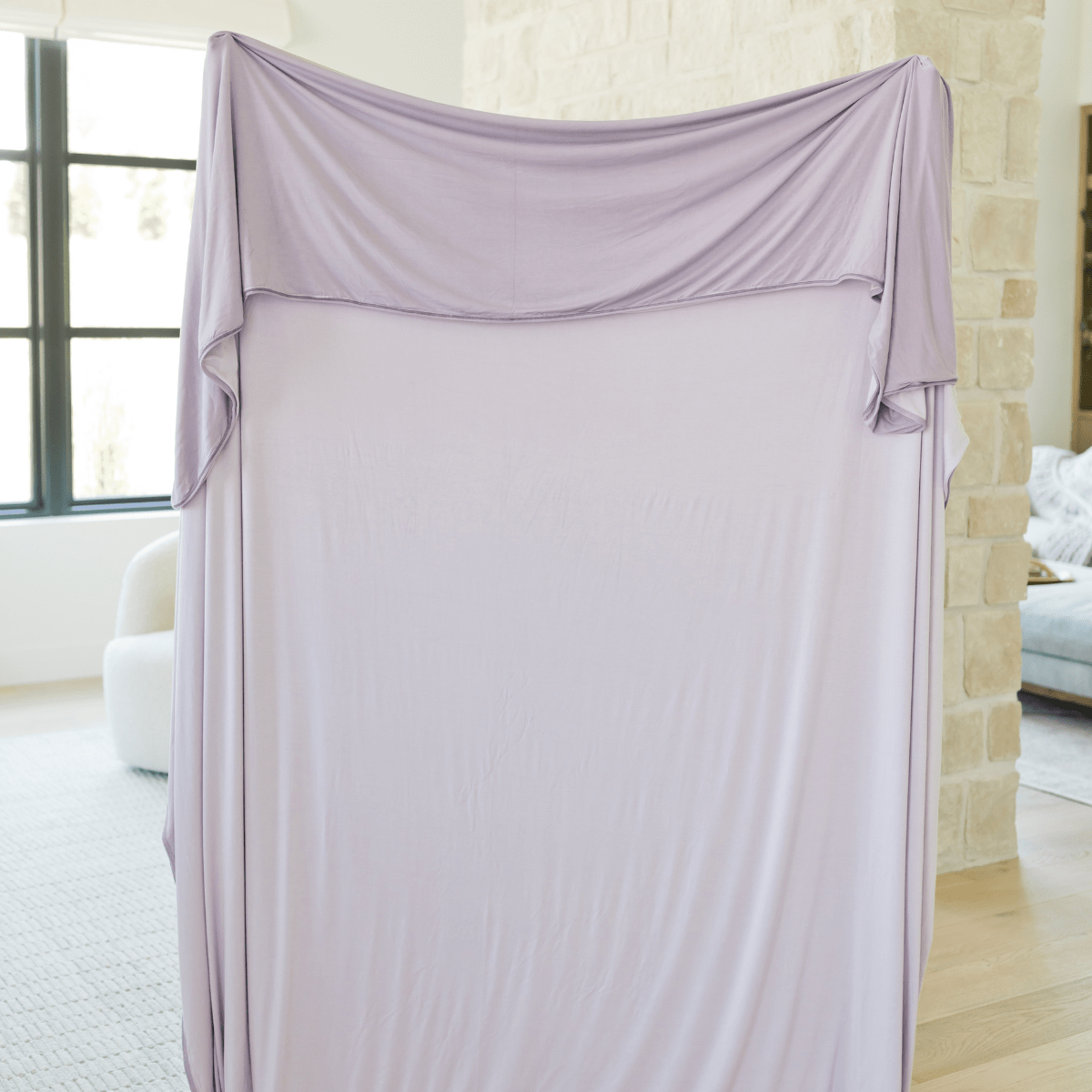 Double sided and reversible hug blanket in lavender and one shade darker purple. 