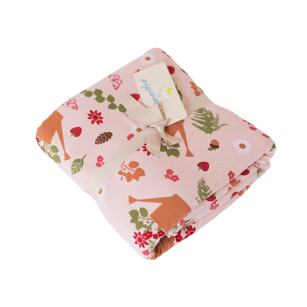 Perfect cottage core adult swaddle blanket with strawberries, acorns, ferns, and watering can print.